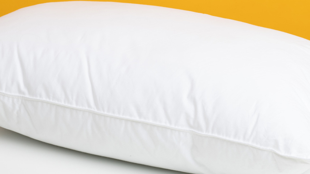 White pillow on white bed