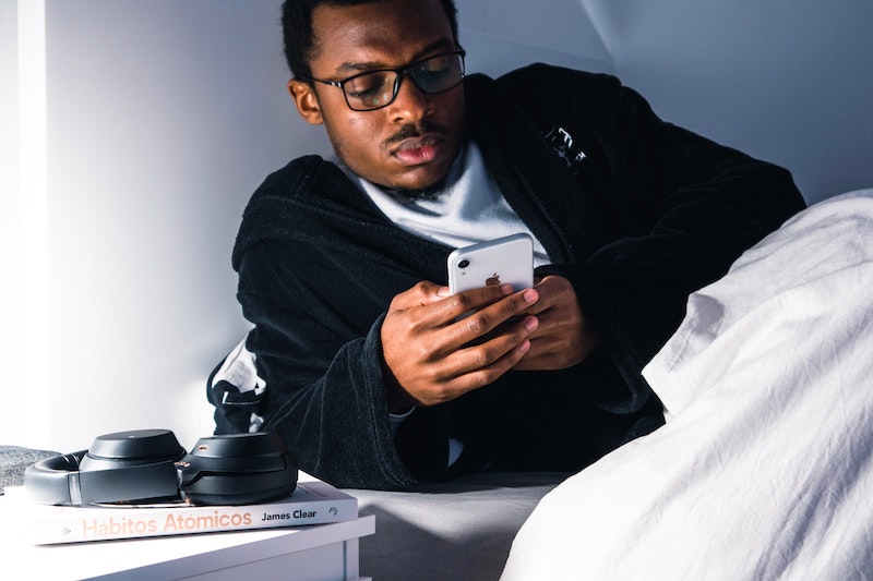Looking at Phone in Bed